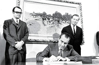 FIG. 1. U.S. President Richard Nixon signs the Clean Air Act of 1970, which called for a significant reduction in air pollutants from industrial and mobility sectors. Photo courtesy  of the U.S. National Archives.